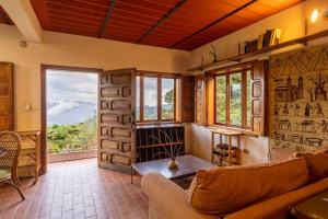 a living room with a couch and some windows at Cabaña duplex el Sosiego. in El Tigre
