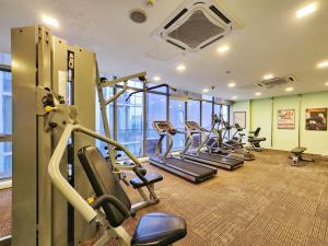 a gym with a row of treadmills and ellipticals at 3min to Pavilion & MRT [1-6Pax] View Menara 118 by MOJI HOME in Kuala Lumpur