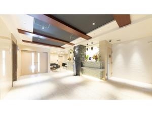 an empty lobby with a fireplace in a building at Eslead Hotel Osaka Tsuruhashi - Vacation STAY 77737v in Osaka