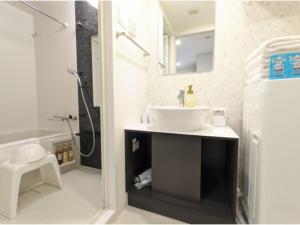 a bathroom with a sink and a shower at Eslead Hotel Osaka Tsuruhashi - Vacation STAY 77569v in Osaka