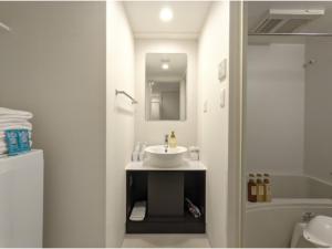 a bathroom with a sink and a mirror at Eslead Hotel Osaka Tsuruhashi - Vacation STAY 77742v in Osaka +3 photos