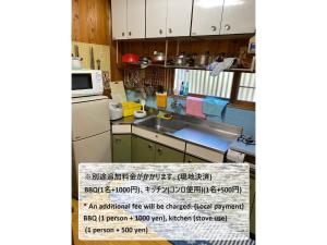 a small kitchen with a sink and a microwave at HANAMIDORI Soshino Sanso - Vacation STAY 16181 in Gujo