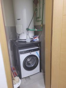 a washer and dryer in a small room at Alsam Real Estate Gust House in Addis Ababa