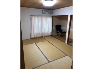 um quarto vazio com uma cadeira e uma janela em HANAMIDORI Oppara no Yado - Vacation STAY 16099 em Gujo