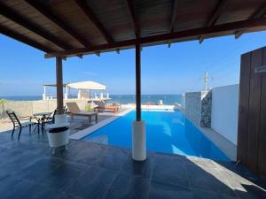 a swimming pool with a view of the ocean at HOUSE WHITE VICHAYITO BEACH in Vichayito