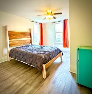 a bedroom with a bed and a ceiling fan at The Second Story in Raton