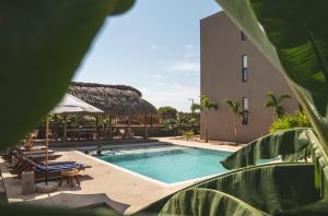 a swimming pool in front of a building at La Barra Resorts Puerto Escondido in Puerto Escondido