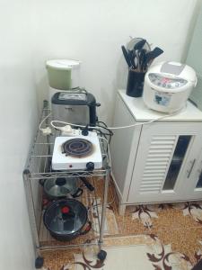 a small kitchen with a stove and a blender at Noana Crib in Davao City