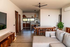 a living room with a couch and a table at La Barra Resorts Puerto Escondido in Puerto Escondido