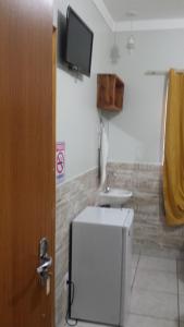 a bathroom with a shower and a sink at Hotel Cerrado in Goiânia