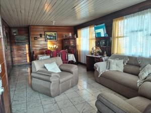 a living room with a couch and a chair at Casa Chicua in Sabanilla