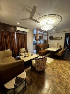 a living room with a couch and a table at 3-BHK with pool & highway view. in Ghaziabad
