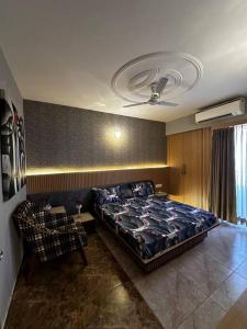 a bedroom with a bed and a couch in it at 3-BHK with pool & highway view. in Ghaziabad