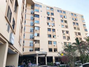 a large apartment building in front of a street at Cozy Patong studio apartment in Patong Beach