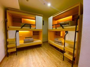 two bunk beds in a room with wooden floors at Hangzhou inn Time Youth Hostel in Hangzhou