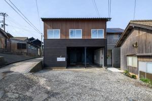 a building with a garage with a door at 子どもがおもいっきり楽しめる一軒家　taiza child in Kyotango