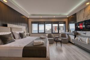 a bedroom with a large bed with chairs and a tv at Swans Hotel Old City Grand Bazaar in Istanbul