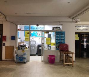 a gas station with a store entrance with a pump at Cozy Patong studio apartment in Patong Beach