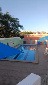 a large swimming pool on a patio next to a building at Apartamento Baiano in Ilhéus