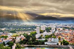 a view of a city with a rainbow in the sky at Excellent T2 - Moderne & Tout Equipé avec Parking in Grenoble