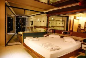 um quarto com uma cama grande e uma banheira em Bali Motel (Adults Only) em Fortaleza