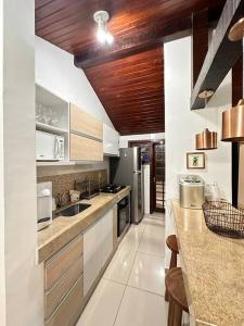 a kitchen with white cabinets and a counter top at Casa Buzios resort in Búzios