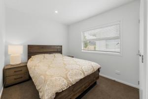 a bedroom with a bed and a window at Close to Town & Lake - Taupo in Taupo