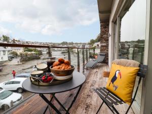 a table with a bowl of food on a balcony at Tidal Waters in Plymouth