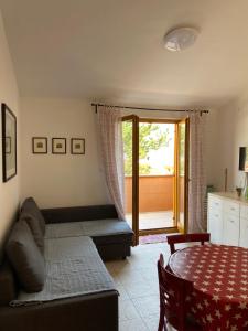 a bedroom with a bed and a table and a door at Apartments Lili in Baška