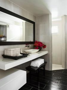 a bathroom with a sink and a mirror at Tamarind Beach Estate in Port Vila