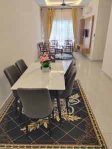 a dining room with a table and chairs at Homestay Ijan in Cyberjaya