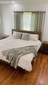 a large bed in a bedroom with a wooden floor at Make A Little Music House in Macon