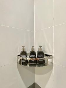 estante en el baño con 3 secadores de pelo en Lakeview Residence Hotel, en Hanói