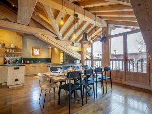 ヴァル・ディゼールにあるChalet de Standing avec Cheminée et Sauna, Proche du Centre de Val-d'Isère - FR-1-694-14のテーブルと椅子のあるキッチンとダイニングルーム