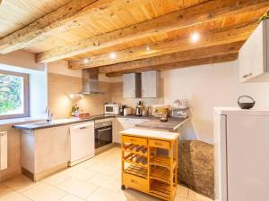 a kitchen with white appliances and a wooden ceiling at Maison Avajan, 3 pièces, 5 personnes - FR-1-695-53 in Avajan