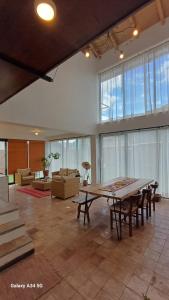 a large living room with a table and chairs at Andahuaylillas Quedate Aqui in Andalmailillas