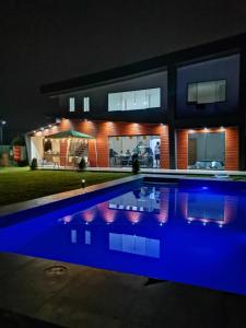 a house with a swimming pool at night at El Refugio de Luisinho in Huaral