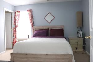 a bedroom with a large bed and a window at Safari House in Concord