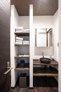 a bathroom with a sink and a mirror at Kobe Motomachi Roji Building - Vacation STAY 16197 in Kobe