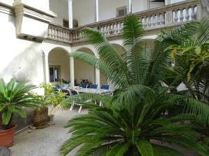 una gran palmera en una habitación con mesas y sillas en Sol na Baia en Vila Nova Sintra