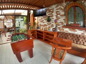 a bar with a foosball table and a couch at ArtPlaza in Quito