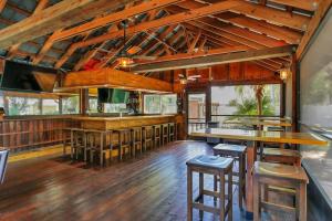 a bar with wooden floors and wooden stools at Seaside Oasis 52 in Fort Myers