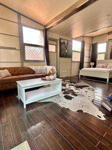 a living room with a couch and a table at Katherine Farmstay Caravan Park in Katherine