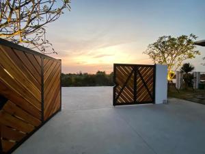 a pivot gate in a driveway with the sunset in the background at BEAUCHAMP VILLA in Ấp Bình Yên