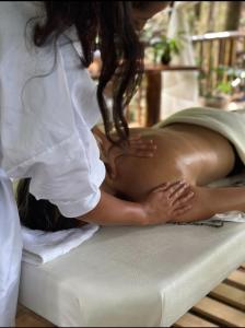 a woman is laying on a bed in a massage at Montelena Glamping in Vergara