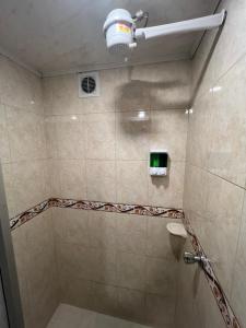 a bathroom with a shower with a toilet and a light at Hermoso apartamento cerca al aeropuerto! in Bogotá +20 photos