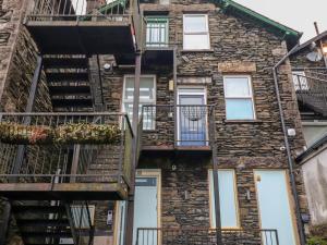 an old stone building with stairs and a fire escape at Windermere Crescent in Windermere