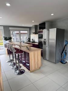 a kitchen with a counter and a refrigerator at Villa Alia in Gérardmer