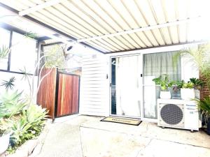 an outdoor patio with plants and a heater at Happy Studio in NewCastle in Minmi