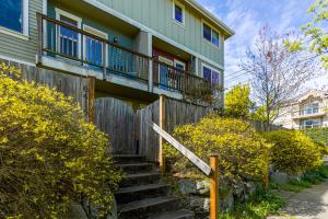 a house with a wooden fence and stairs at Stylish North Seattle Townhouse- Dual Master Suites in Seattle